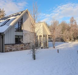 A house in a snowy outdoor area at Red Deer Lodge Feshiebridge near Aviemore