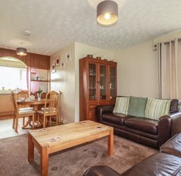 A living room with a dining area and furniture at Underlanes in Boscastle
