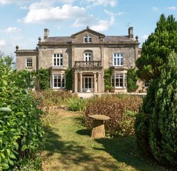 A house with a garden and trees at Milton Manor in Milton On Stour
