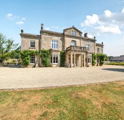 A house with windows and an entrance at Milton Manor in Milton On Stour