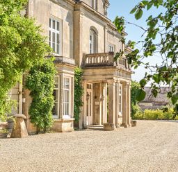 A building with columns and windows at Milton Manor in Milton On Stour