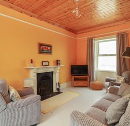 A living room with armchairs a sofa a fireplace and a television at Newtown East near Kilkee County Clare