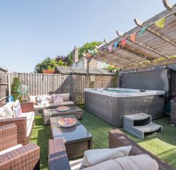 A garden with outdoor seating and a hot tub at The Boars Head Pub in Bishop's Castle