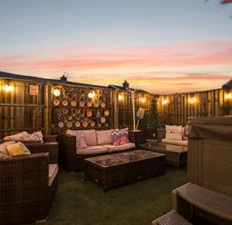 An outdoor seating area with sofa and coffee table at The Boars Head Pub in Bishop's Castle