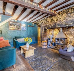 A living room with a fireplace and seating area at The Boars Head Pub in Bishop's Castle