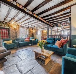 A snug with comfortable seating and a coffee table at The Boars Head Pub in Bishop's Castle
