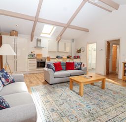 A living room with a sofa and coffee table at Tregona Buckland Monachorum near Yelverton