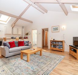 A living room with a sofa and coffee table at Tregona Buckland Monachorum near Yelverton