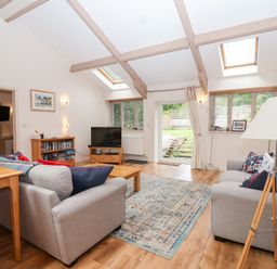 A living room with a sofa and coffee table at Tregona Buckland Monachorum near Yelverton