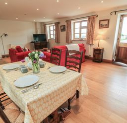 A dining room with a table set for meals at Bramble Cottage Babcary near Lydford-On-Fosse