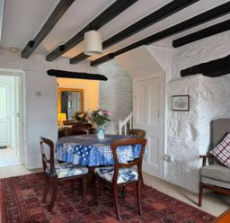 A dining room with a table and chairs at Derlwyn in Newport, Pembrokeshire