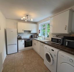 A kitchen with appliances and cabinets at Derlwyn, Newport, Pembrokeshire