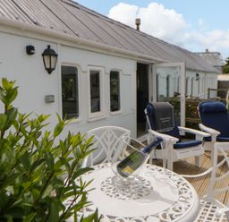 An outdoor area with a table and chairs at Clifftop Carriage in Aberporth, Ceredigion