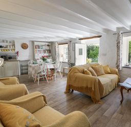 A living room with a sofa and dining table at End Cottage, Newport, Pembrokeshire
