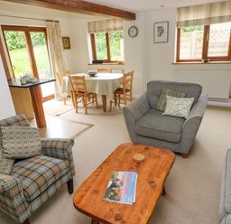 A living room with sofa and dining area at Brynawelon in Newport, Pembrokeshire