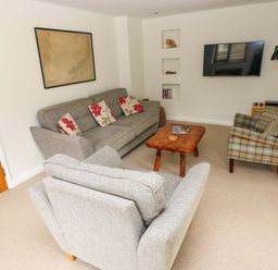 Living room with seating and a television at Brynawelon in Newport, Pembrokeshire