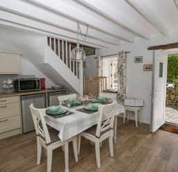 A dining area with a table and chairs at Middle Cottage in Newport, Pembrokeshire