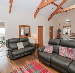 A living room with sofas and a coffee table at Y Felin in Cardigan, Ceredigion