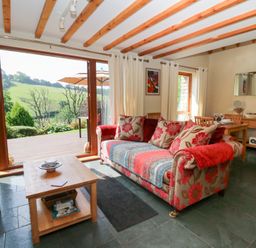 A living room with a sofa and coffee table at Dan Castell Cottage in Llandeilo, Carmarthenshire