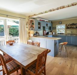 A kitchen with a dining table and chairs at Dolwylan Newport, Pembrokeshire