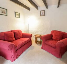 A living room with a sofa and an armchair at Panteg, Cardigan Llangoedmor Cardigan