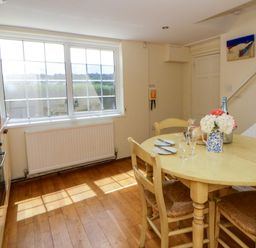 A kitchen with a dining table and chairs at Beach Retreat in Aberporth