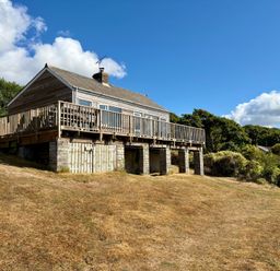 A house with a deck and steps in the outdoor area at Beach Cove Freshwater East, Pembrokeshire