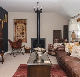 A living room with a leather sofa and fireplace at 1 Church Barns in Pocklington