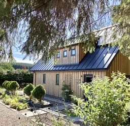 A house with a garden and pathway at Larchwood Lodge in Ellon
