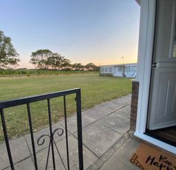 A view of a lawn and trees from an entrance at 246 California Road, California, Norfolk