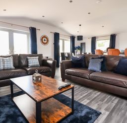 A living room with two brown leather sofas and a wooden coffee table at Box Tree Escapes in Wennington near Kirkby Lonsdale