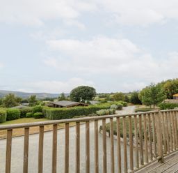 A view from a wooden deck overlooking a garden at Mountain View in Rhayader