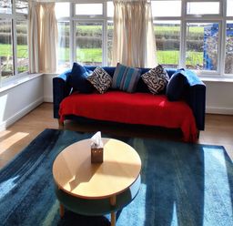 A living room with a sofa and coffee table at Buttercups at Midway in Kington