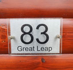 A house number sign 83 on a wooden wall at Great Leap in Louth