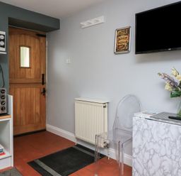 A kitchen with a door and microwave at Hidden Treasure Brixham