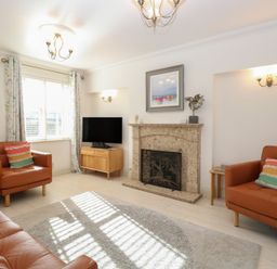 A living room with a television and fireplace at 5 Styleman Road, Hunstanton