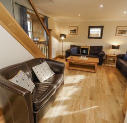 A living room with sofas and a coffee table at Low Croft in Embleton