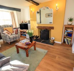 A living room with a coffee table and sofa at Buttonhole Cottage in Ambleside