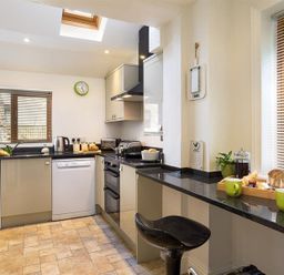 A kitchen with appliances on countertops including a kettle and toaster at Hill Cottage in Ambleside