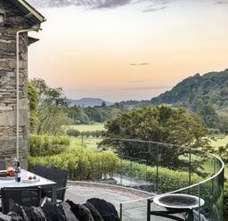 An outdoor dining area with a view of hills at Take Five in Ambleside