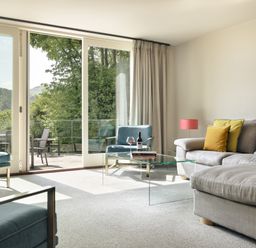 A living room with a sofa and armchairs at Take Five in Ambleside