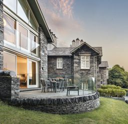 A patio area with a table and chairs at Take Five in Ambleside