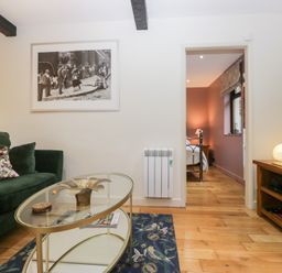 A living room with a sofa and coffee table at Corner Cottage in Troutbeck
