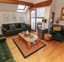 A living room with sofas and a coffee table at Workshop Cottage in Bowness