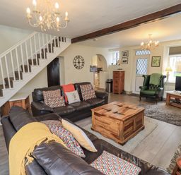 A living room with a sofa and coffee table at Smithy Cottage at Bowland Bridge Bowness