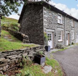 An outdoor view of a stone building with a path and planter at Beck Steps in Chapel Stile