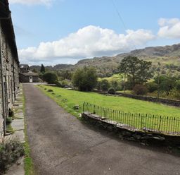 An outdoor area with stone houses and a pathway at Beck Steps in Chapel Stile