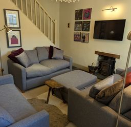 A living room with sofas and a television at Beck Steps in Chapel Stile