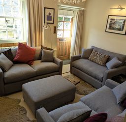 A living room with sofas and an ottoman at Beck Steps in Chapel Stile
