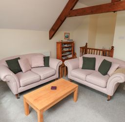A seating area with two sofas and a wooden coffee table at The Old Chapel in Crook